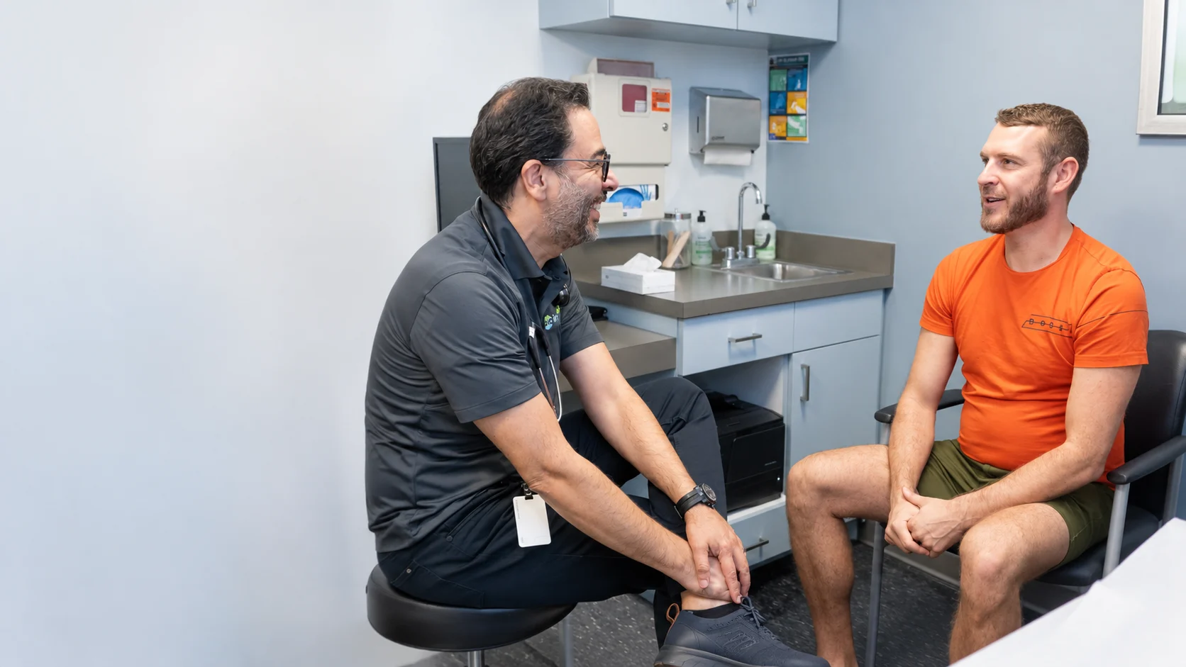 OIC Inspired physician talking with a patient in an exam room