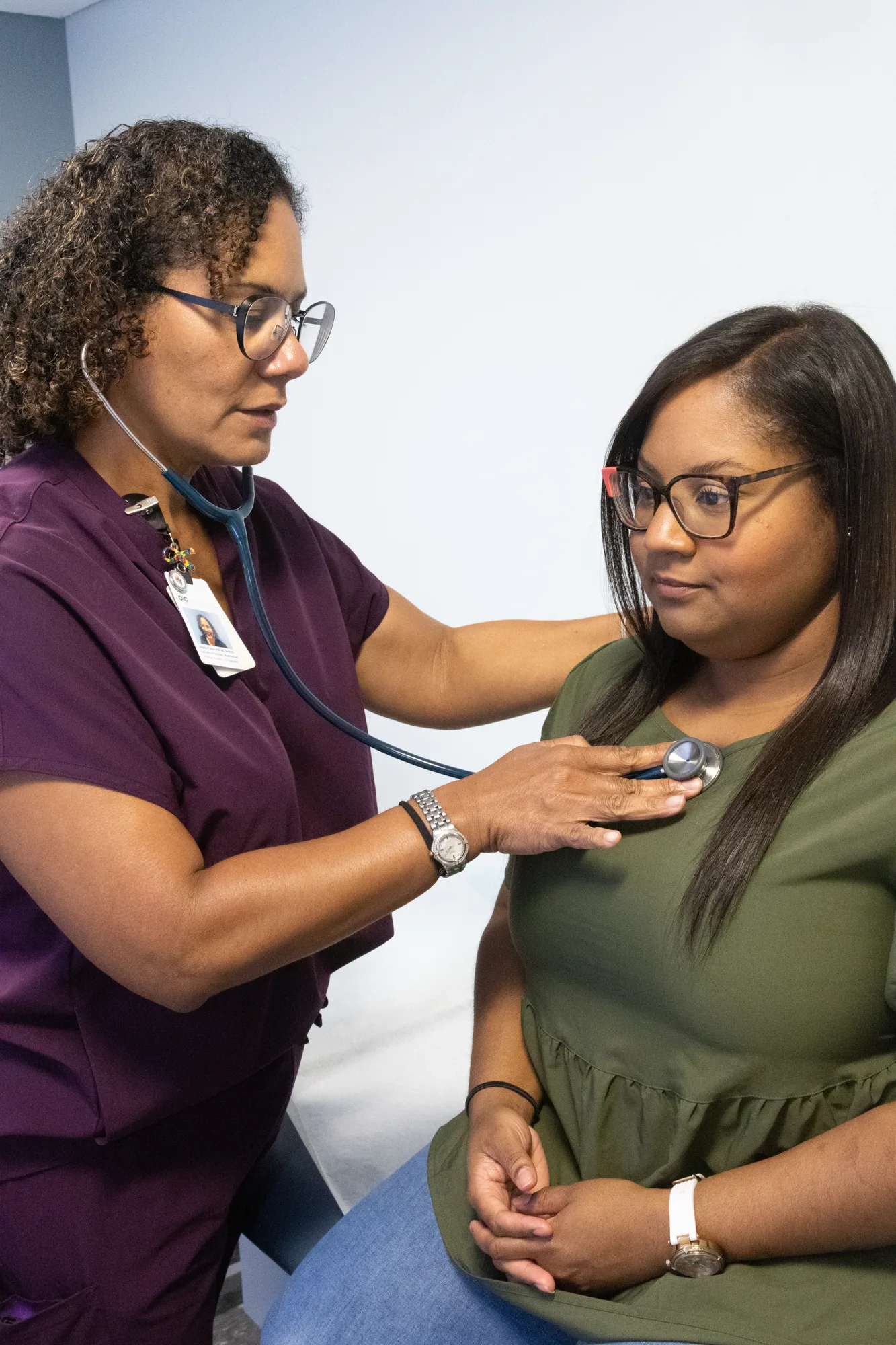 OIC Inspired nurse practitioner listening to a patient's heart