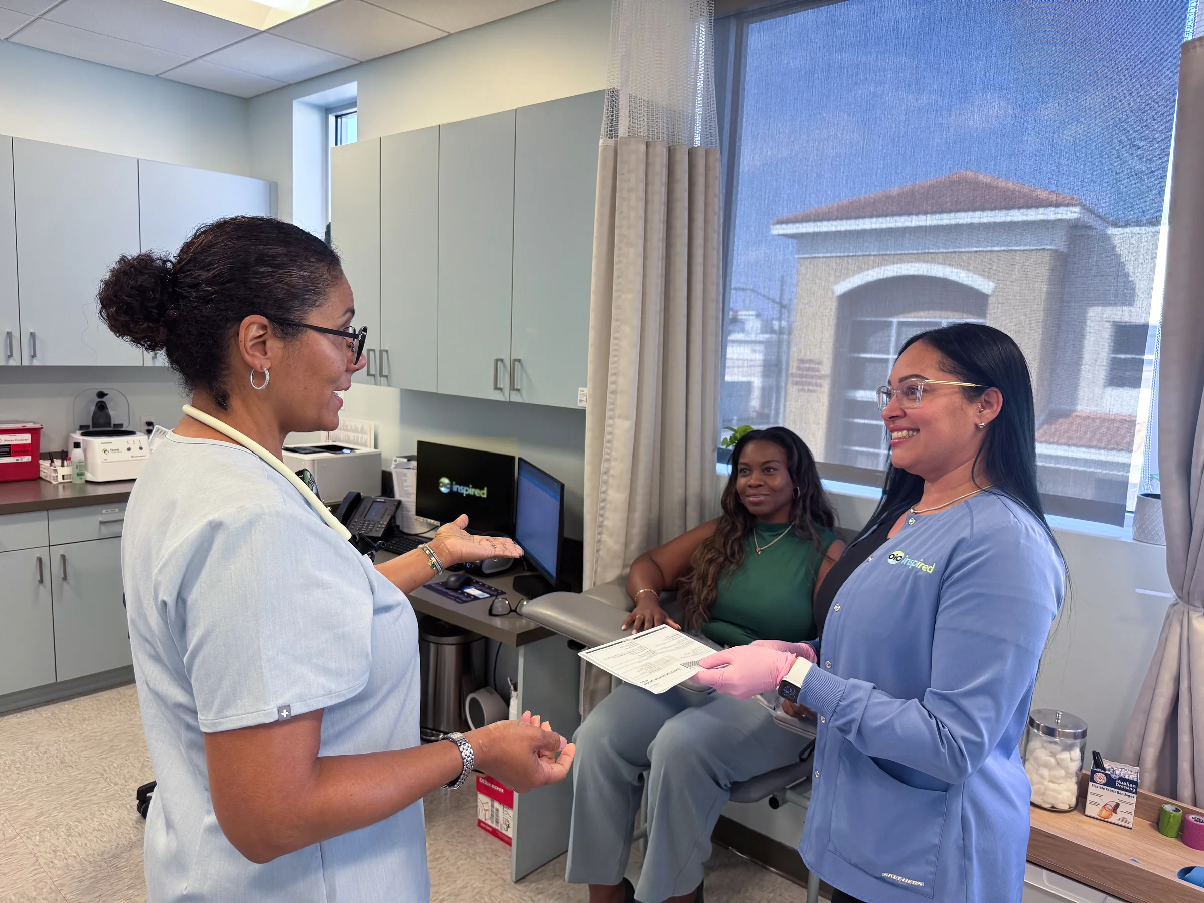 OIC Inspired laboratory staff with a patient in the draw room